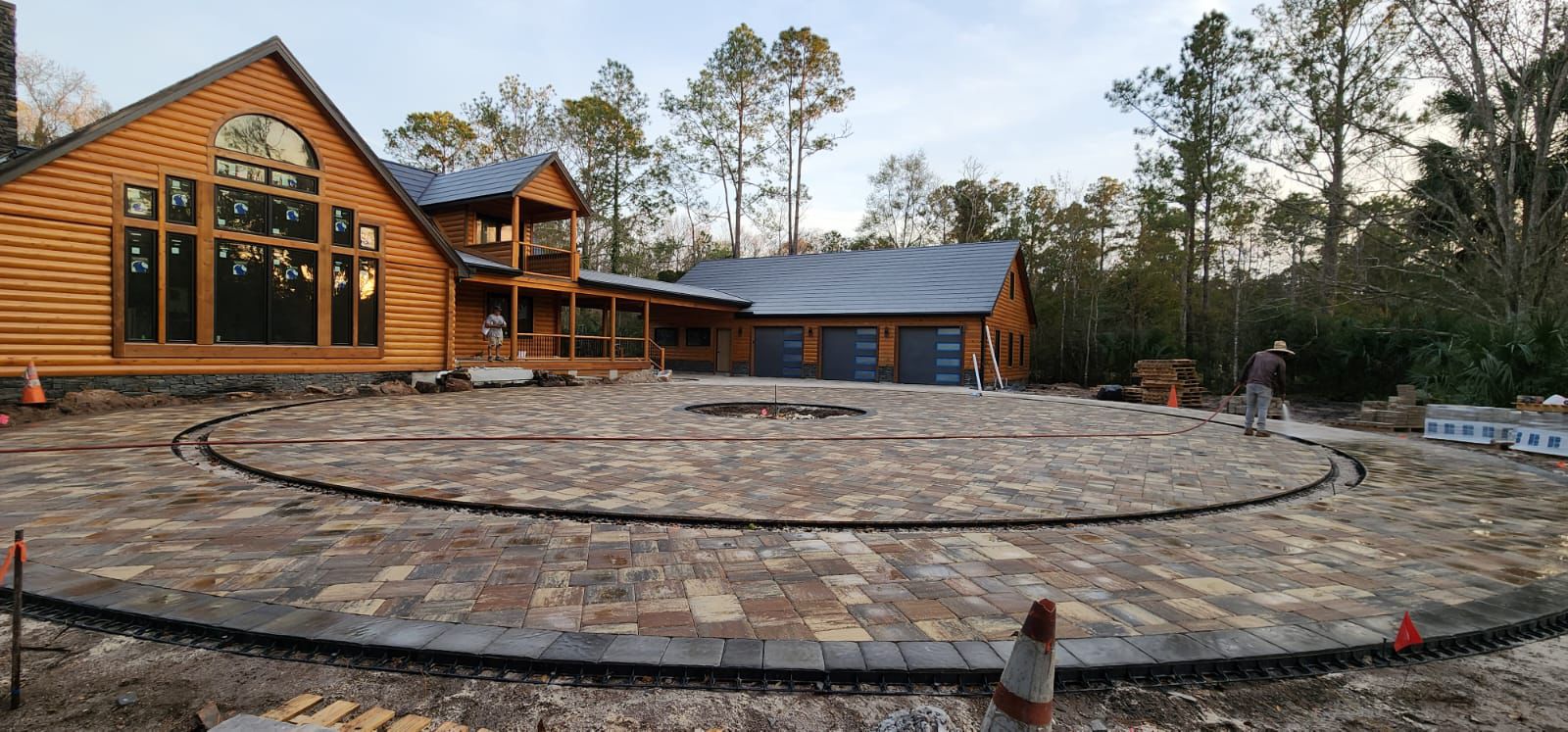 Paver installation crew laying and leveling pavers on a Jacksonville driveway
